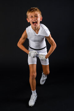 Young football player celebrating big play with excited victory shout