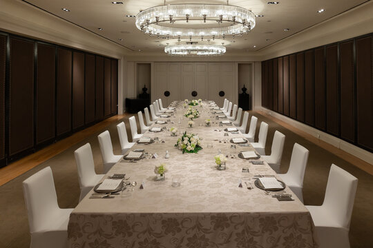 Luxury Executive Boardroom Dining Setup with Elegant Long Table and Chandeliers