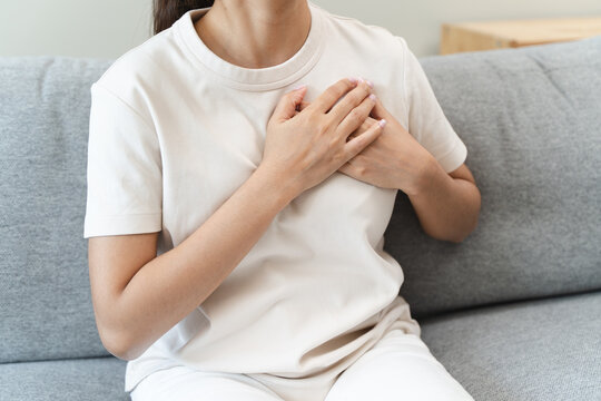 Close-up woman touching chest feeling pain heart attack symptom