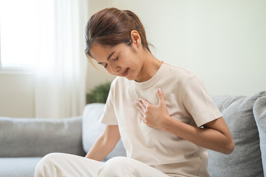 Close-up woman touching chest feeling pain heart attack symptom