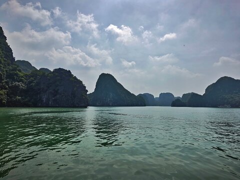 Lan Ha Bay, Haiphong City, Vietnam. The bay is recognized by UNESCO as a natural world heritage site, with limestone mountains formed millions of years ago, and vegetation, surrounding a bay in a trop