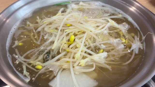 Clear monkfish soup (agu-jiri) boiling in a pot with bean sprouts 아구탕 아구지리 맑은 국