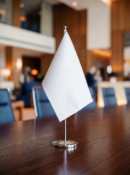 Small elegant white desk flag on a polished conference table
