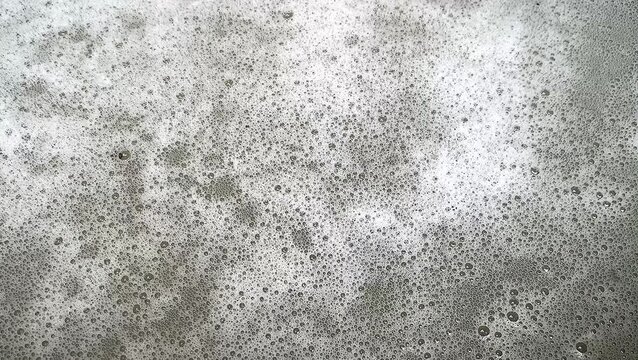Foamy soap bubbles and water wave ripple texture motion background. soft water wave movement.