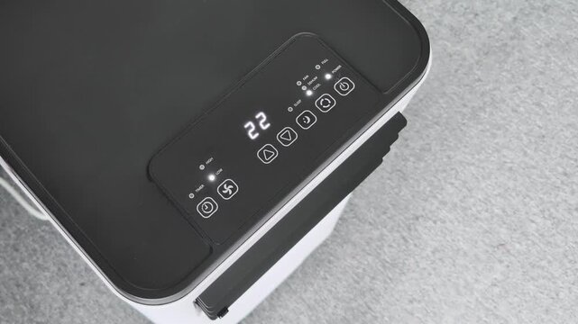 Turning on a portable room air conditioner for the first time in a indoor space