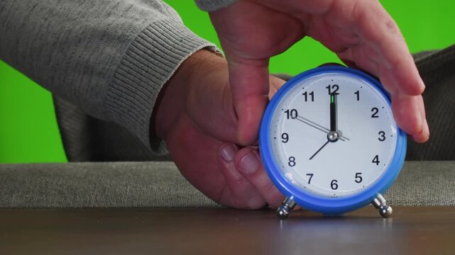 Turning clocks back winter time change on green screen background