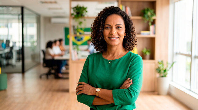Confident woman with arms crossed in modern office environment