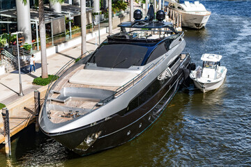 Fototapeta premium Yacht charter. Sea vacation on summer. Luxury boat motor yacht in marina. Luxury yacht heading out to sea from marina. Boating and yachting tourism. Luxurious life style. Vacation on summer