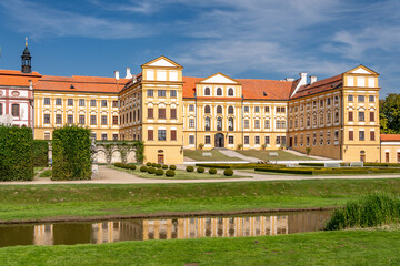 Naklejka premium Jaromerice Chateau in the Czech Republic, surrounded by a park. Jaromerice Chateau on a sunny day. A garden with flowers and shrubs surrounds the castle. A beautiful Baroque chateau.