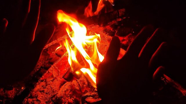 Warming Hands By Small Campfire