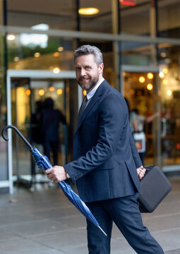 Professional business man wear suit and hold umbrella. Business boss portrait man. Successful business. Success of entrepreneur. Office manager at business break. Successful businessman go to office
