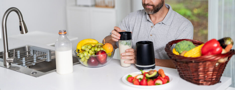 Morning breakfast. Healthy smoothie breakfast in morning. Man prepare breakfast in kitchen, healthy lifestyle. Hispanic man making smoothie. Diet morning food. Man organic food. Vitamin boost