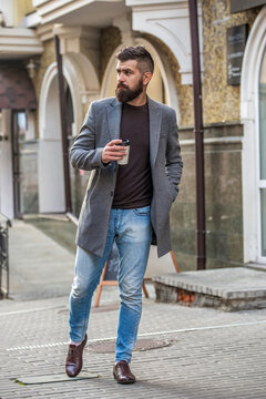 Coffee break and everyday routine. Bearded man having coffee in city street. Handsome man on street holding cup coffee. Business lifestyle, break. Man drinking morning coffee