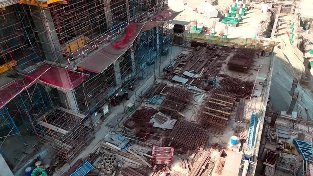 Panoramic view of skyscraper building construction progress in an urban commercial zone.
