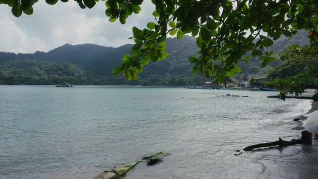 Sapzurro Bay in choco region in Colombia, in the Caribbean Sea featuring fishing boats and a jungle-covered mountain