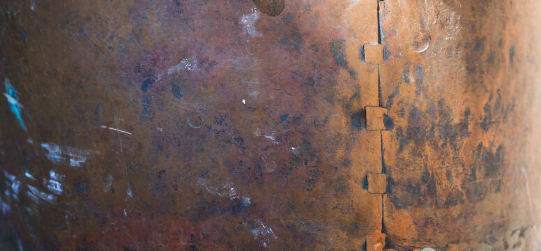 Riveted Copper Surface with Vertical Seam. Light from the Right. Free Space for Design. Shallow depth of field. 