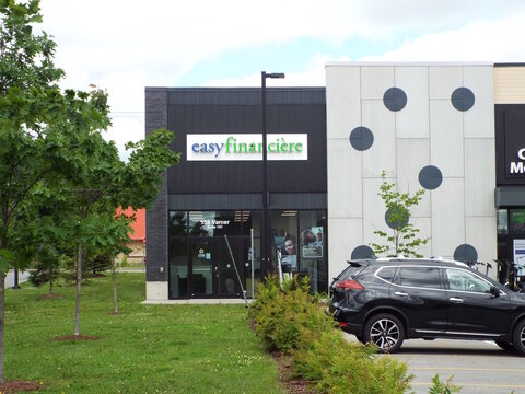 Gatineau, Quebec, Canada &ndash; June 13, 2026: An "easyfinancial" storefront with bilingual signage stands in a commercial plaza next to a parked black SUV under a cloudy sky at 555 Chem. Vanier Unit 101.
