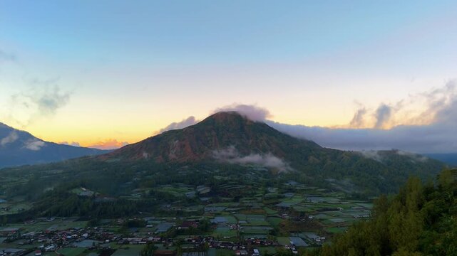 Aerial pan across Mount Batur volcano at sunrise, Kintamani Bali
