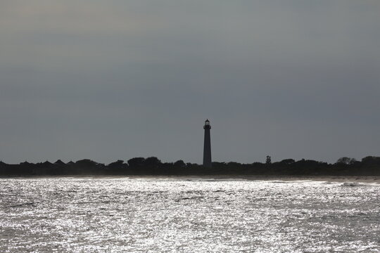 A solitary image of the Cape May Lighthouse sitting across the opposite end of the bay.