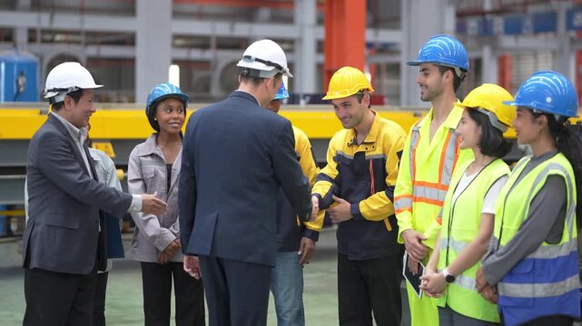 Meeting among workers in a factory setting during the day