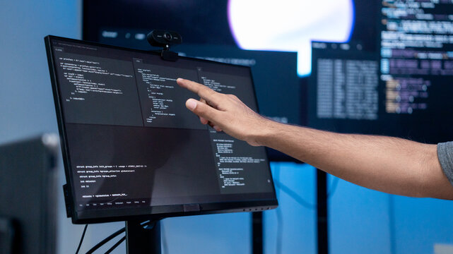 Close up shot show hand software engineer pointing to computer screen, checking for error or inaccurate in the coding Cyber security. Professional programmer work verifying dashboard data development