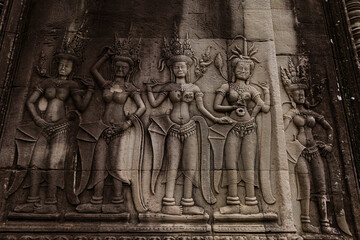Fototapeta premium Ancient stone carving of a female Apsara dancer inside Angkor Wat temple in Siem Reap, Cambodia