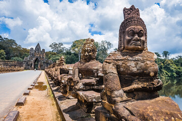 Fototapeta premium Ancient stone guardian statues lining the causeway at the South Gate of Angkor Thom in Siem Reap, Cambodia