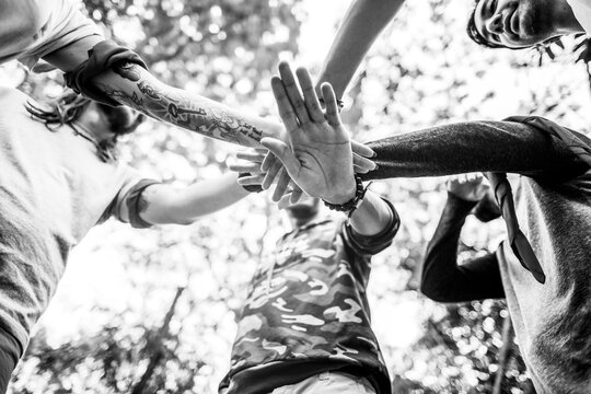 Teamwork hands stack in circle outdoor unity concept