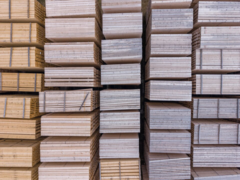 Aerial view of stacked timber planks in a lumber yard, showcasing industrial wood storage and sustainable forestry materials in Bruneck, Trentino-Alto Adige, Italy.