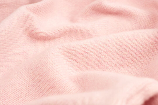 Soft pink cashmere sweater texture background.