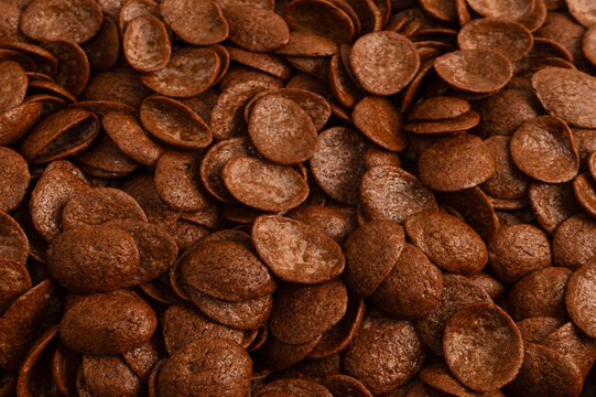 Corn-flakes background and texture. Chocolate cereal.