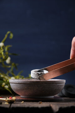 Preparation for an incense ritual on Yule - placing a glowing charcoal in a censer