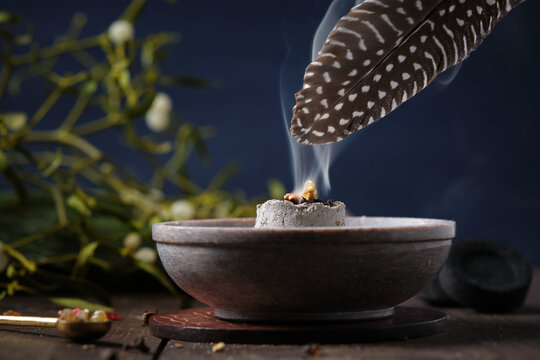 Incense ritual on Yule - spreading smoke with a feather