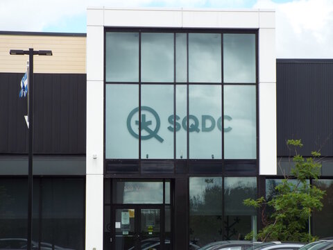 Gatineau, Quebec, Canada &ndash; June 13, 2026: The "SQDC" storefront featuring large glass windows and bilingual signage stands along Chem. Vanier under an overcast sky at 559 Chem. Vanier Unit 102 A.