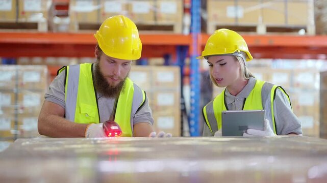 Workers scan packages in a warehouse while using a hand scanner and tablet