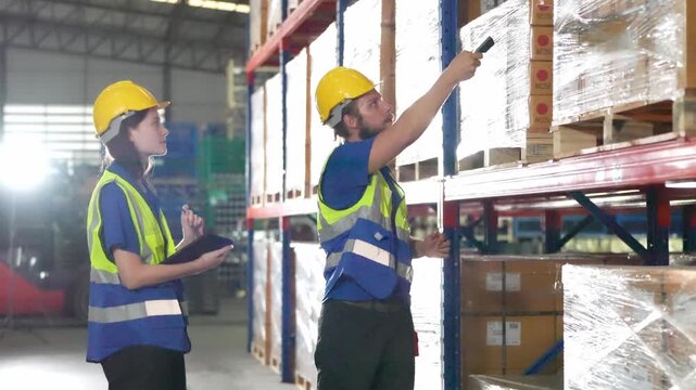 Workers check inventory in a warehouse with shelves full of boxes and plastic wraps during daytime