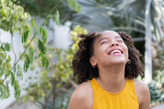 Smiling teen girl finding joy and happiness outdoors