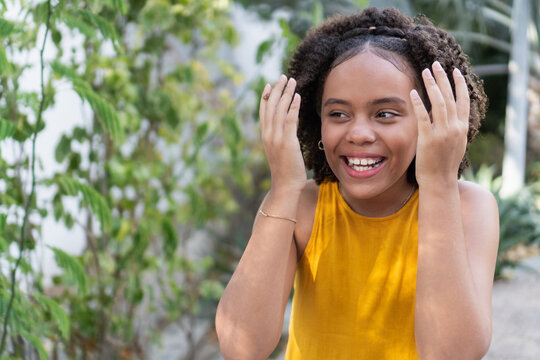 Happy teen girl smiling with curly hair