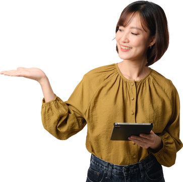 Asian woman tablet presentation smile hand isolated cutout, holding tablet while presenting open palm with friendly expression