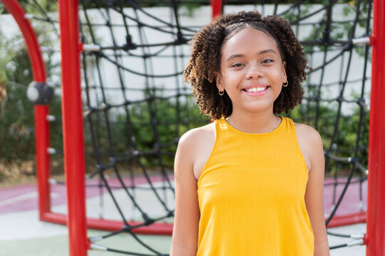 Happy young girl smiling at playground outdoors