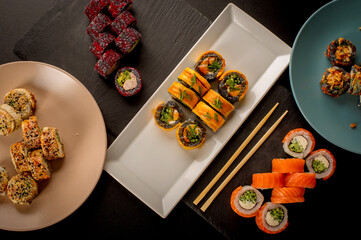 Top view flat lay of various sushi sets served on multiple plates © Ilias