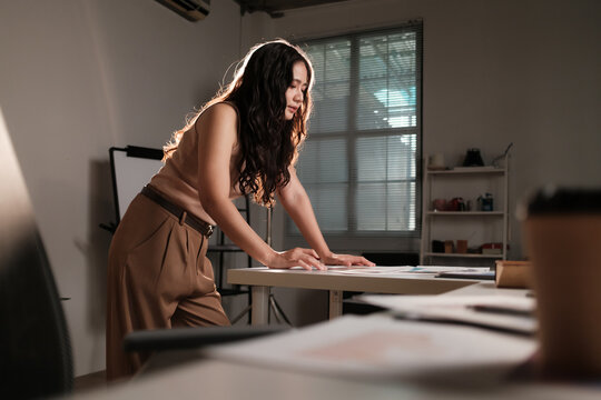 Young woman working on creative project in studio