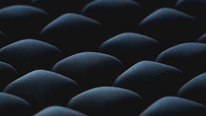 Obraz premium Macro black inflatable ergonomic seat cushion texture with selective focus, massage cubes, and modern geometric pattern for ergonomic product placement, workplace wellness, orthopedic health concepts.