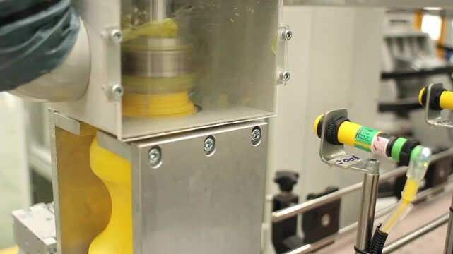 Automated plastic container sealing on a factory production line
