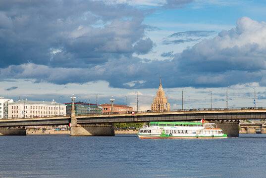 Riga, Latvia - August 27, 2025: A picture of a cruise on the Daugava River, with the Latvian Academy of Sciences and the Stone Bridge behind it.
