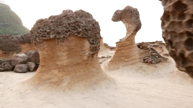 Incredible balance of thin hoodoo stone, Yehliu Geopark odd shapes of eroded rocks, mushroom stone field. Fantastic yet natural geological formations, shown by first person view camera move forward.