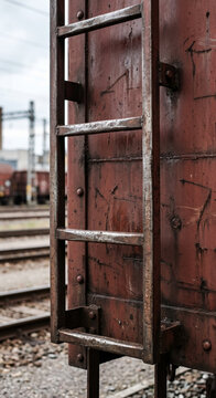 Freight boxcar side ladder and sliding door detail showing industrial metal hardware used for railway cargo access and inspection