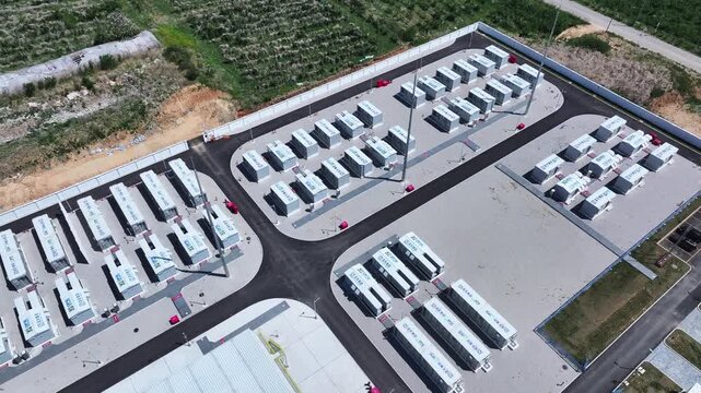 Aerial view of large-scale energy storage station with battery container arrays arranged in orderly rows