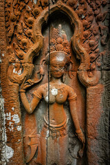 Fototapeta premium Ancient stone carving of a female Apsara dancer inside Angkor Wat temple in Siem Reap, Cambodia