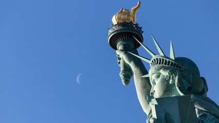 Statue of Liberty looking to the moon on a sunny day, in New York, United Staes © ph_sadore